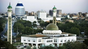 KHARTOUM, SUDAN - JANUARY 9, 2007: A general view of the city center and the As Sayed Ali Mosque (R) and an innovative building (L) shaped like a boat sail that will host a new hotel built by a Lebanese company are seen on January 9, 2007 in Khartoum, Sudan. Khartoum, the capital of Sudan, lies at the point where both the Blue and the White Nile converge and in recent years has been best known for the political turmoil which stems from it's government. Within this war torn city lays the largest commercial construction site in Africa known as Al Mogran Project, which spans 1,500 acres, at a place known as Alsunut from the name of its nearby forest. With the help of foreign Chinese workers, the Sudanese Alsunut Development Company LTD, owned by the Dal Group - the first industrial group of the country, are working furiously to develop a new Dubai which is to become the commercial and financial headquarters of Islamist East Africa. The site is to include multiple modern office towers, duplexes and golf courses. The project is to cost USD $4billion and is scheduled to house both the headquarters of the Greater Nile Petroleum Operating Company as well as Petrodar, both of which are Chinese, Malaysian, Indian and Sudanese joint venture oil companies and is due to be complete within the next five to fifteen years. (Photo by Marco Di Lauro/Getty Images)