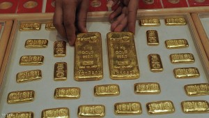 An Indian saleswoman arranges gold bars