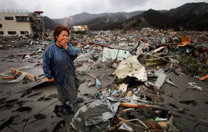 Reiko Miura, 68, cries as she looks for her sister's son at a tsunami-hit area in Otsuchi, Iwate Prefecture, northern Japan, Wednesday, March 16, 2011, after Friday's earthquake and tsunami. (AP Photo/Itsuo Inouye)